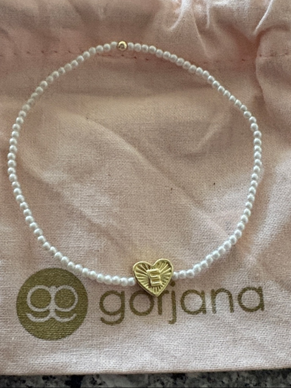 Brand new with pouch Gorjana letter “E” stretch bracelet
